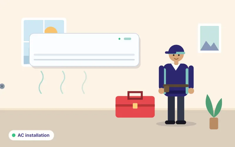 Illustration of a technician standing beside a newly mounted split air conditioner with a toolbox at their feet